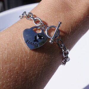 Women`s silver tone heart charm toggle bracelet